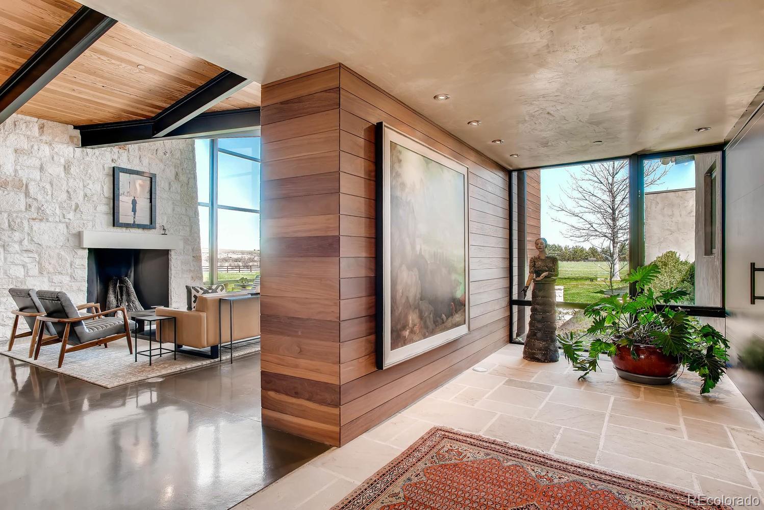 7983 Valmont Road Boulder, CO 80301 - Photo 5 of 31 a living room with furniture large windows and wooden floor