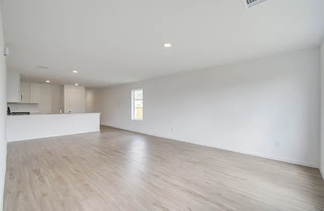 a view of kitchen with kitchen island wooden floor and window