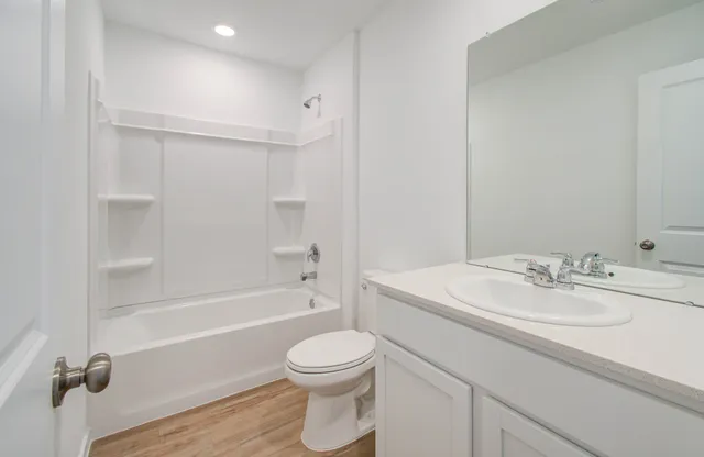 a bathroom with a sink a toilet and a bathtub