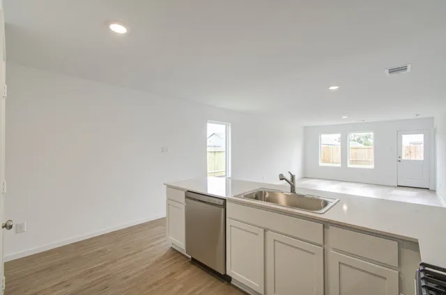 a kitchen with sink and window