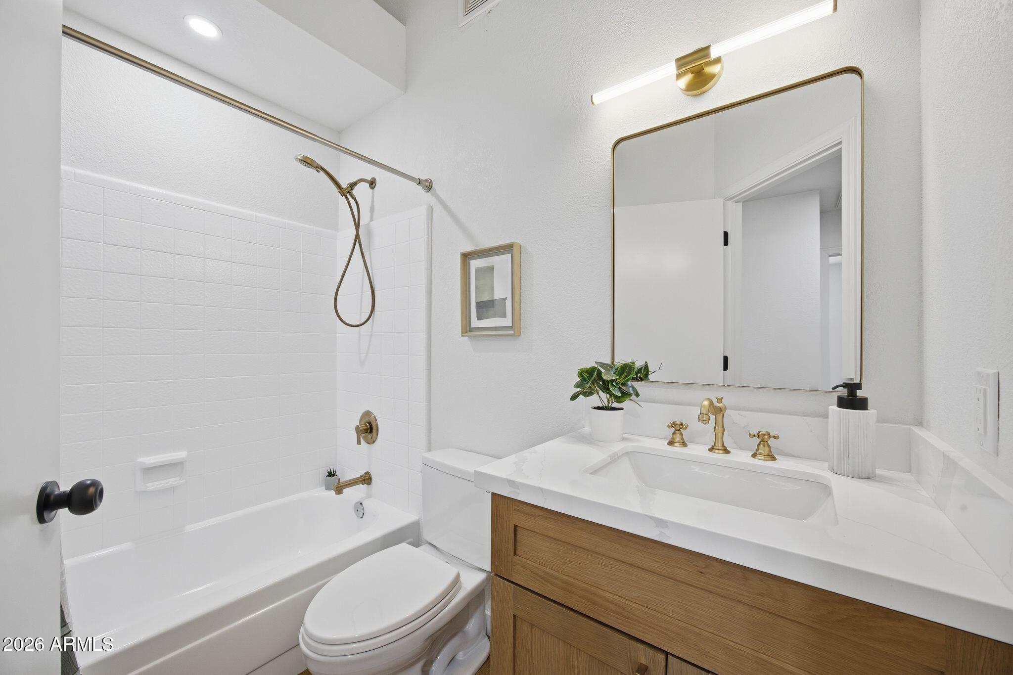 3134 East McKellips Road, Unit 69 Mesa, AZ 85213 - Photo 18 of 24 a bathroom with a sink a toilet and a mirror