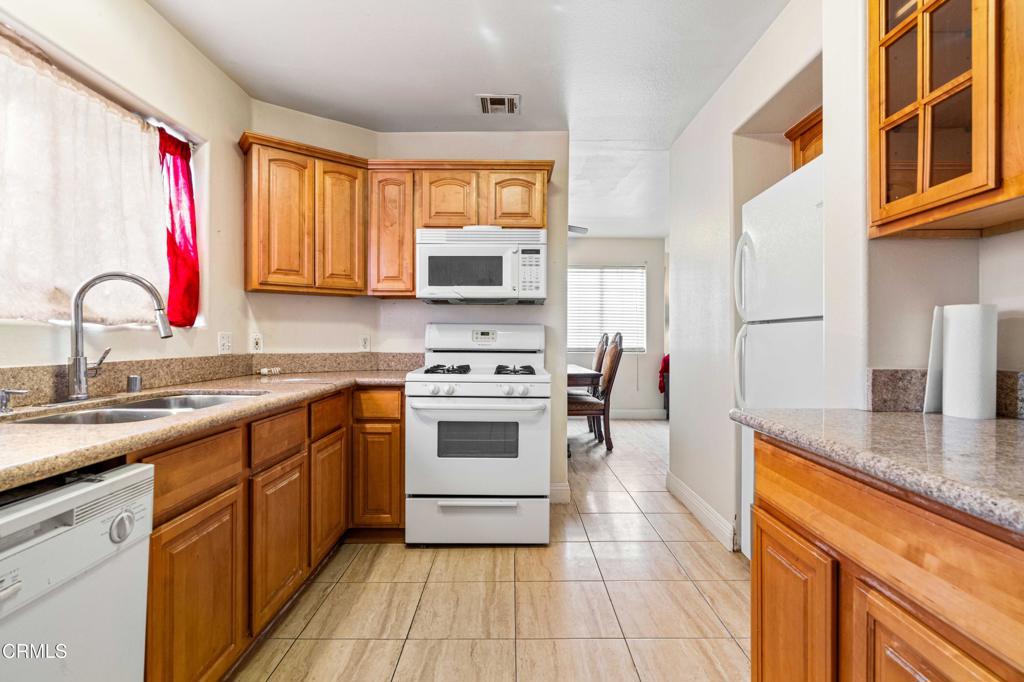 907 West Mission Road, Unit B Alhambra, CA 91801 - Photo 7 of 27 a kitchen with stainless steel appliances granite countertop a sink stove and refrigerator
