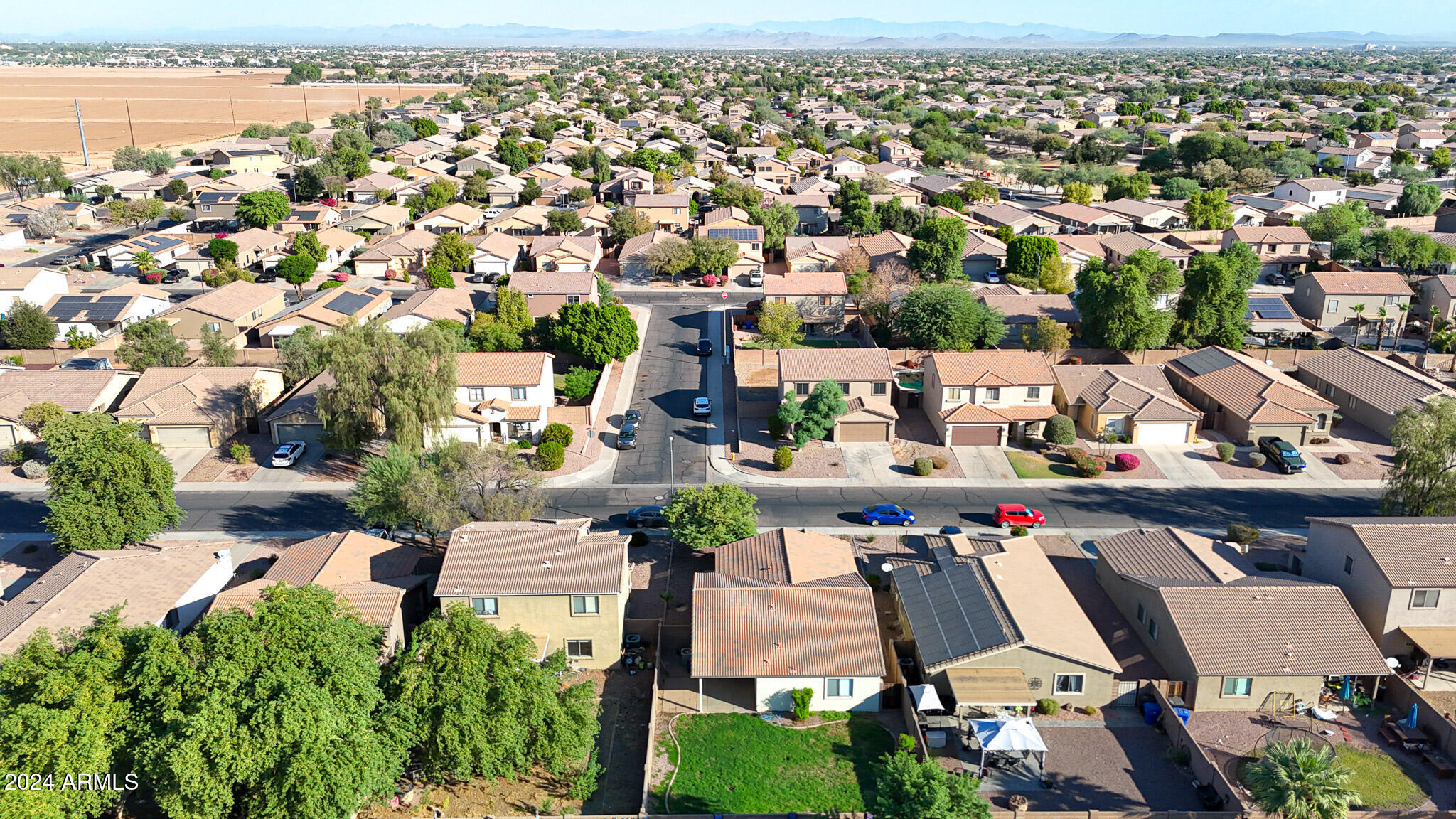 16193 West Calavar Road Surprise, AZ 85379 - Photo 32 of 43 an aerial view of residential houses with outdoor space and parking