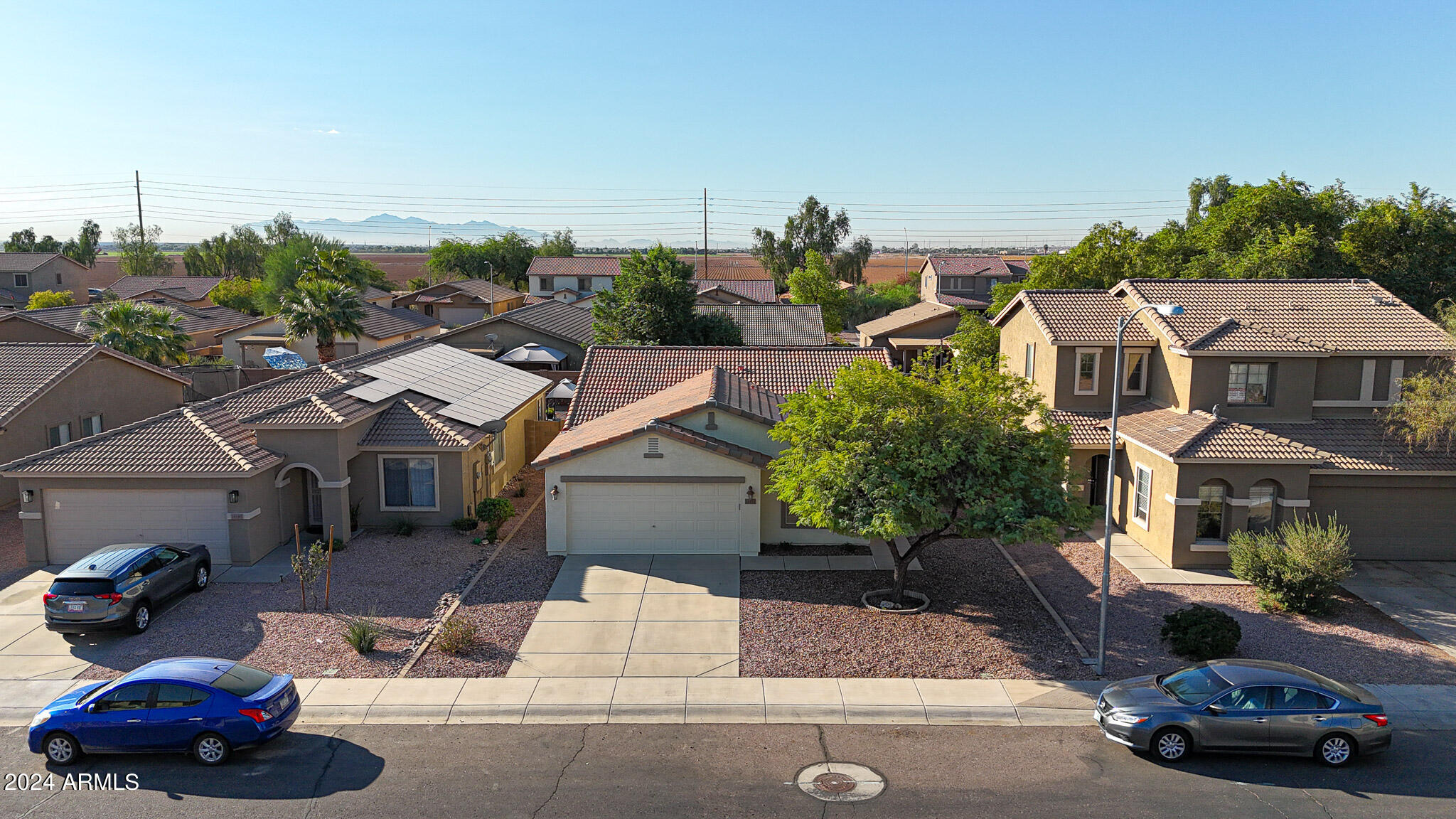 16193 West Calavar Road Surprise, AZ 85379 - Photo 33 of 43 a car parked in front of a house