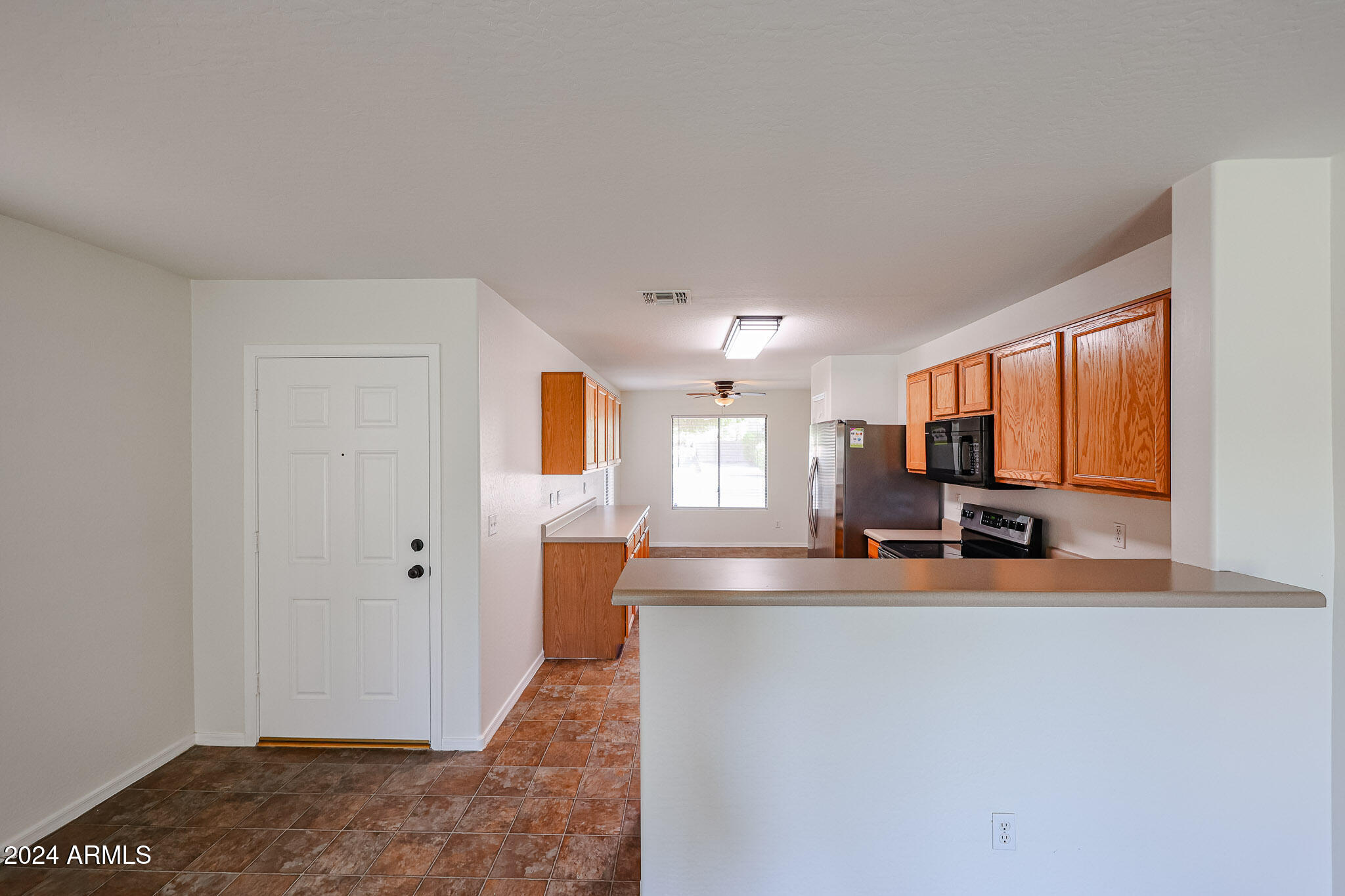 16193 West Calavar Road Surprise, AZ 85379 - Photo 7 of 43 a view of a living room a kitchen island with furniture and a window