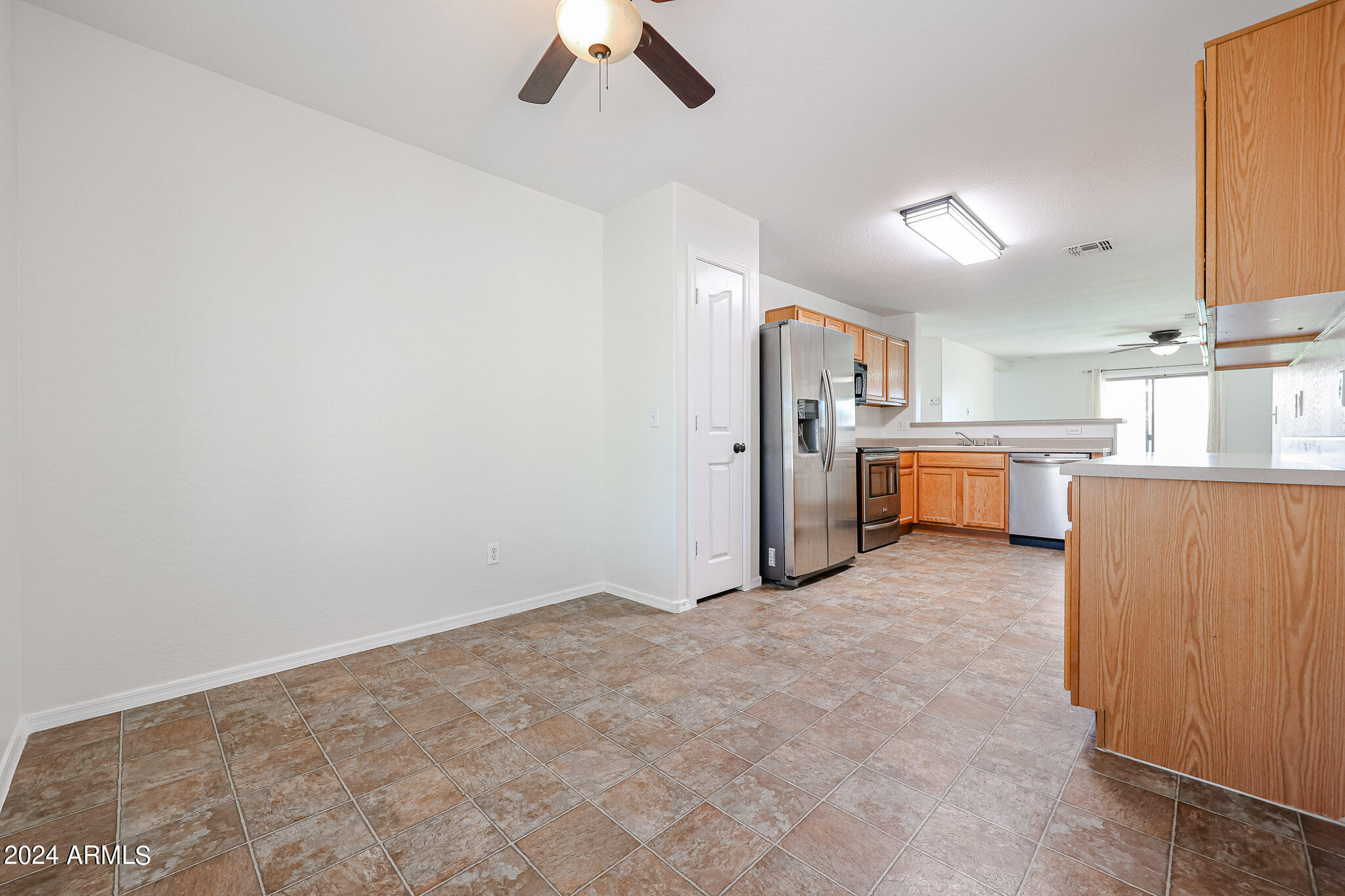 16193 West Calavar Road Surprise, AZ 85379 - Photo 8 of 43 a view of a kitchen with a stove top oven and cabinets