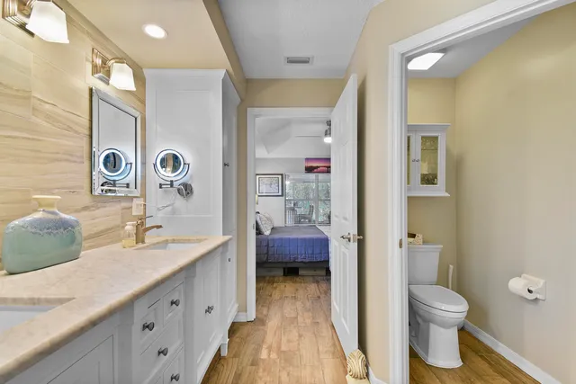 a bathroom with a double vanity sink toilet and shower