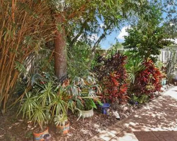 a front view of a building with trees