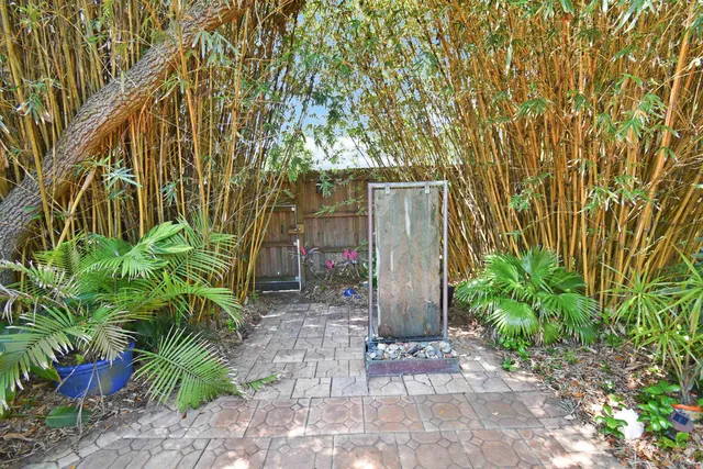 a sign board with a tree in front of it