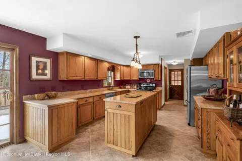 a kitchen that has a lot of cabinets in it and appliances