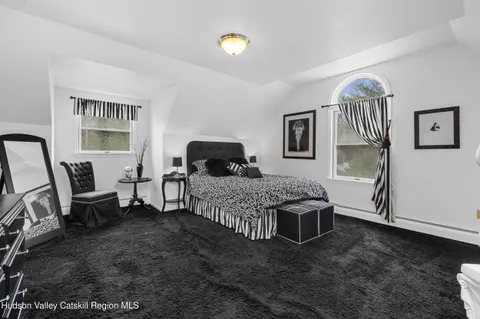 a bedroom with bed and cabinets