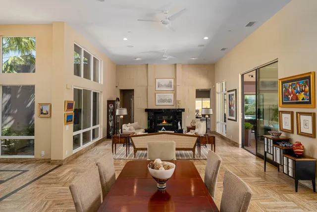 a living room with furniture and large windows
