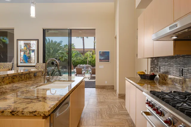 a bedroom with a bed and large flat tv screen on the dresser