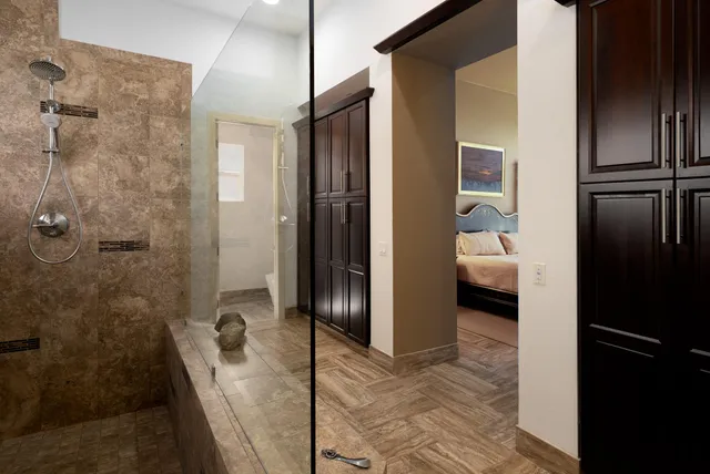 a bedroom with a bed and a flat screen television