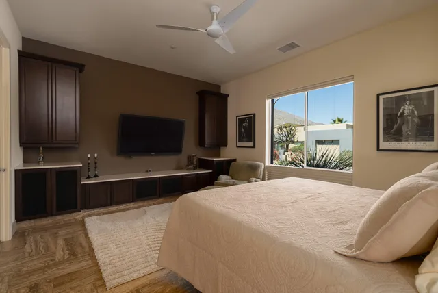 a spacious bedroom with a bed and a large window