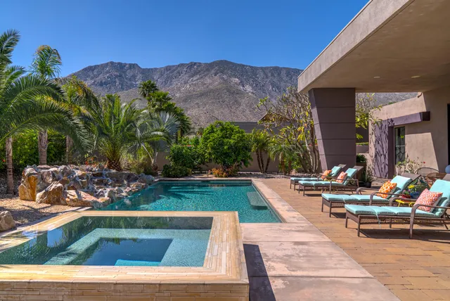 a view of a house with backyard porch and sitting area