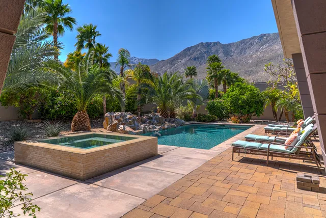 a view of yard from deck with patio