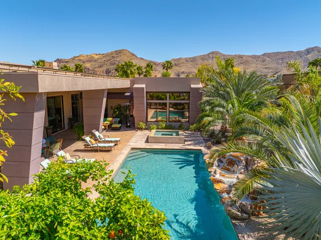 a view of a patio with table and chairs and potted plants
