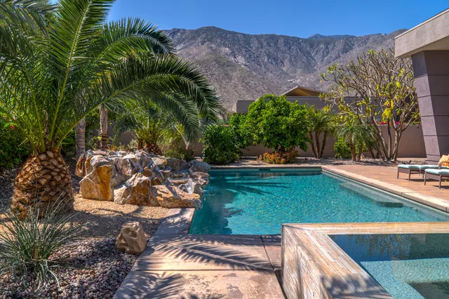 a front view of a house with a yard and a garage