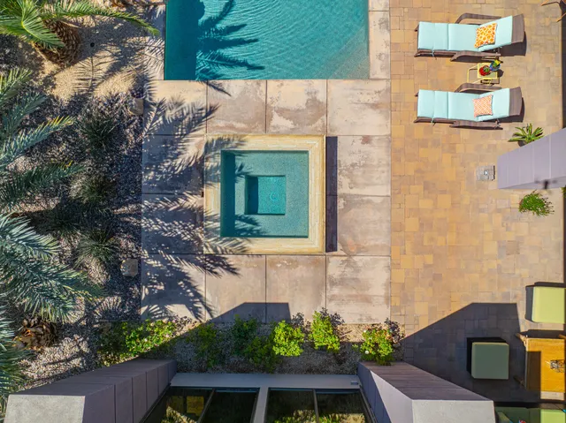 a front view of a house with a yard and potted plants