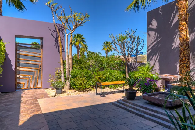 a living room with furniture kitchen view and a large window