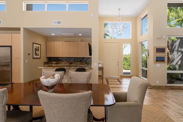 a living room with furniture and large windows