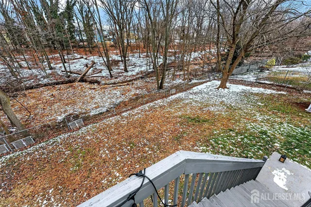 a view of a wooden chairs and bench in the backyard