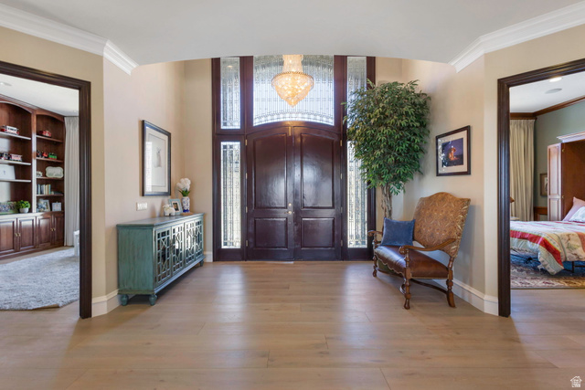 684 North Summit Way Alpine, UT 84004 - Photo 28 of 58 Entryway featuring crown molding, light wood-style floors, and hanging lights