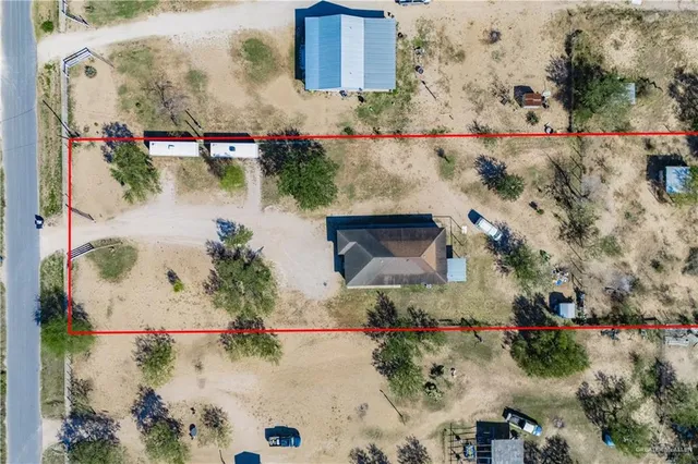 an aerial view of house with a yard