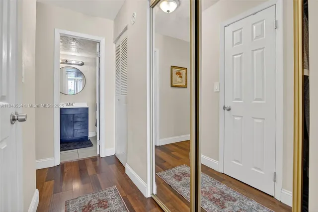 a view of hallway with wooden floor