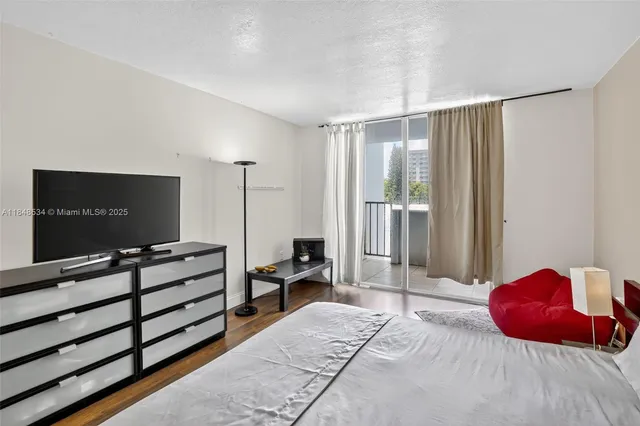 a bedroom with a bed and a flat screen tv