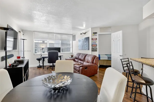 a living room with furniture kitchen view and a fireplace