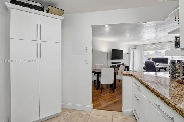 a kitchen with stainless steel appliances granite countertop a sink and a refrigerator