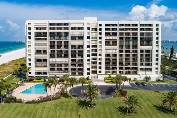 a view of a swimming pool with a yard and lake view in back