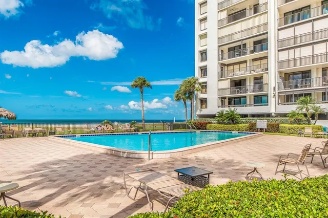 a view of a swimming pool with outdoor seating