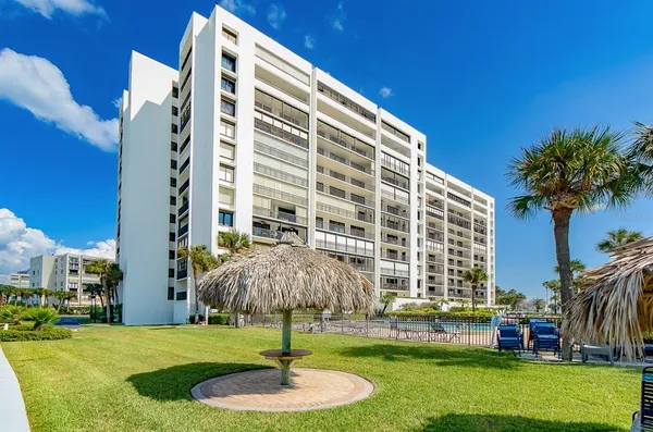 a large bed sitting in a bedroom next to a window