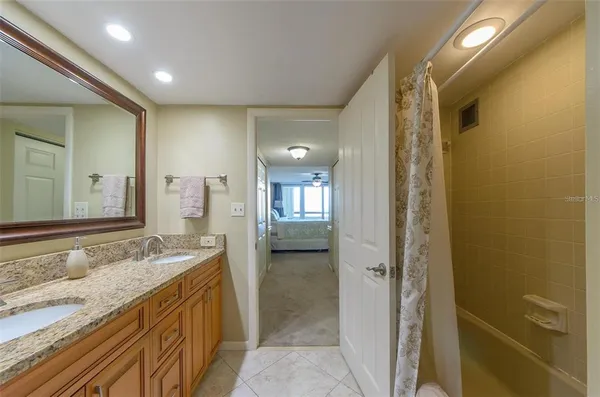 a bathroom with a granite countertop sink and a mirror