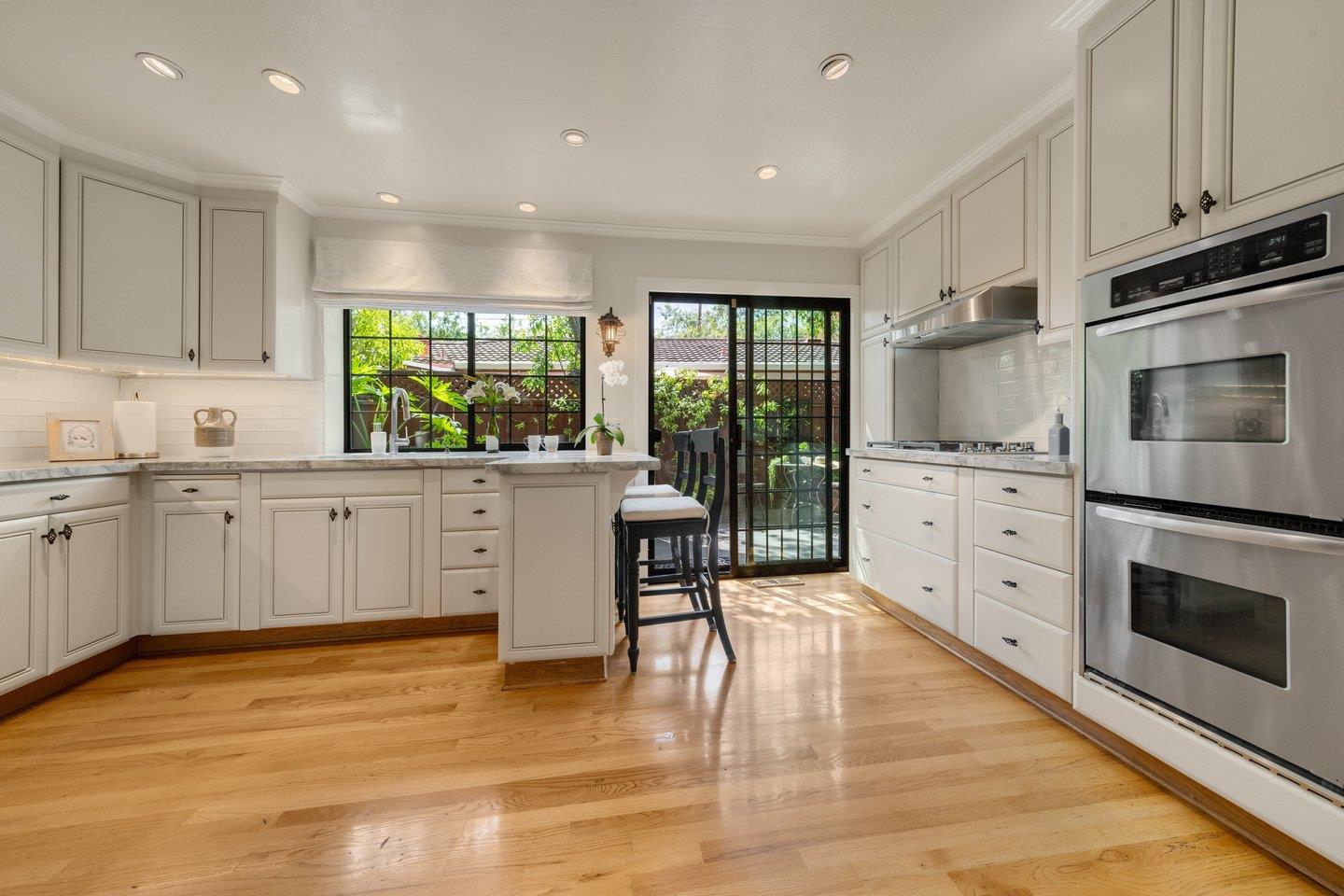 680 Cambrian Drive Campbell, CA 95008 - Photo 15 of 62 a kitchen with stainless steel appliances kitchen island granite countertop a stove a sink and white cabinets