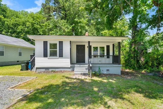 a view of a house with a yard porch and sitting area