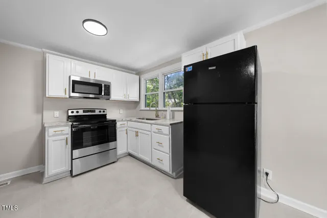 a kitchen with a refrigerator stove and microwave