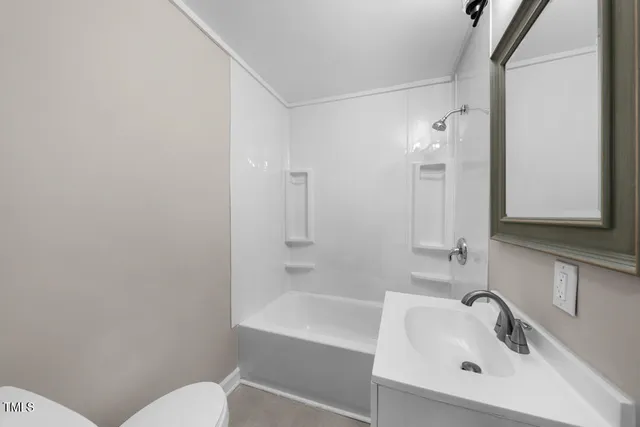 a bathroom with a sink mirror and toilet