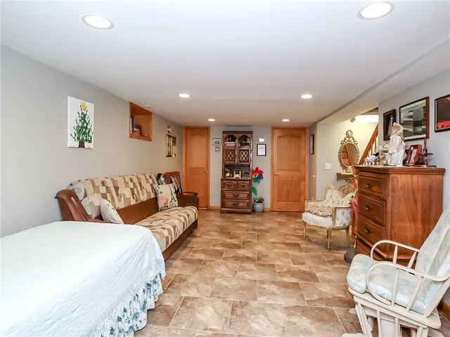 a large bedroom with a bed and furniture