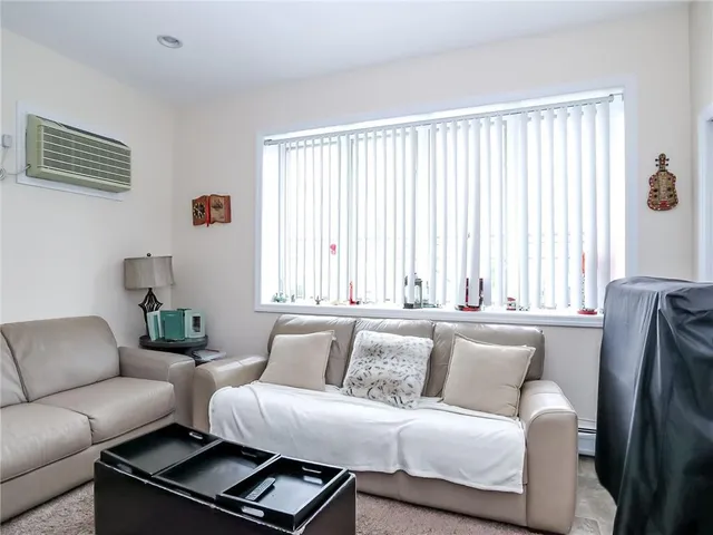 a living room with furniture and large window