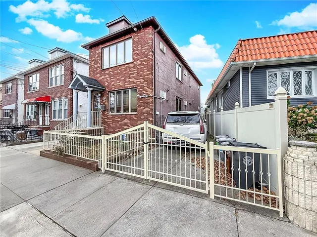 a view of a house with iron fence