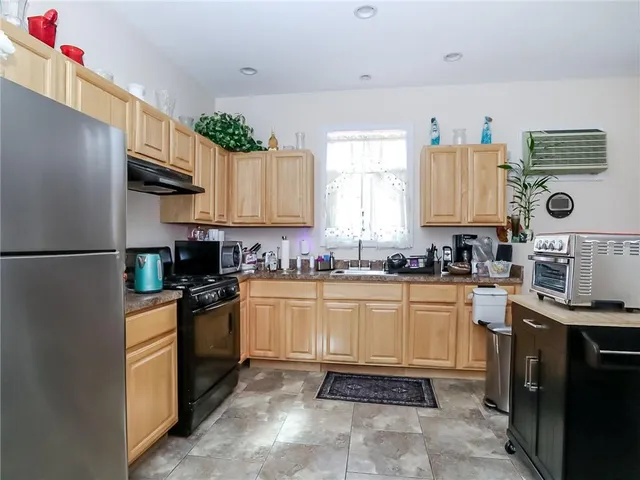 a kitchen with stainless steel appliances granite countertop a refrigerator sink and cabinets