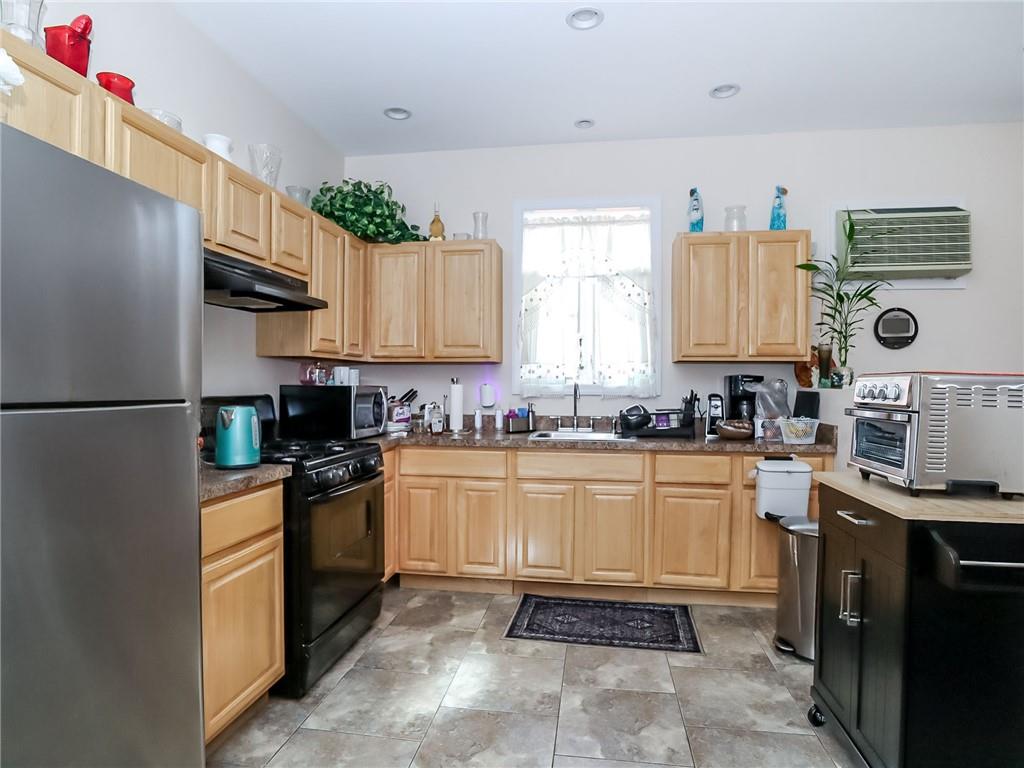 480 Van Sicklen Street Brooklyn, NY 11223 - Photo 22 of 31 a kitchen with stainless steel appliances granite countertop a refrigerator sink and cabinets