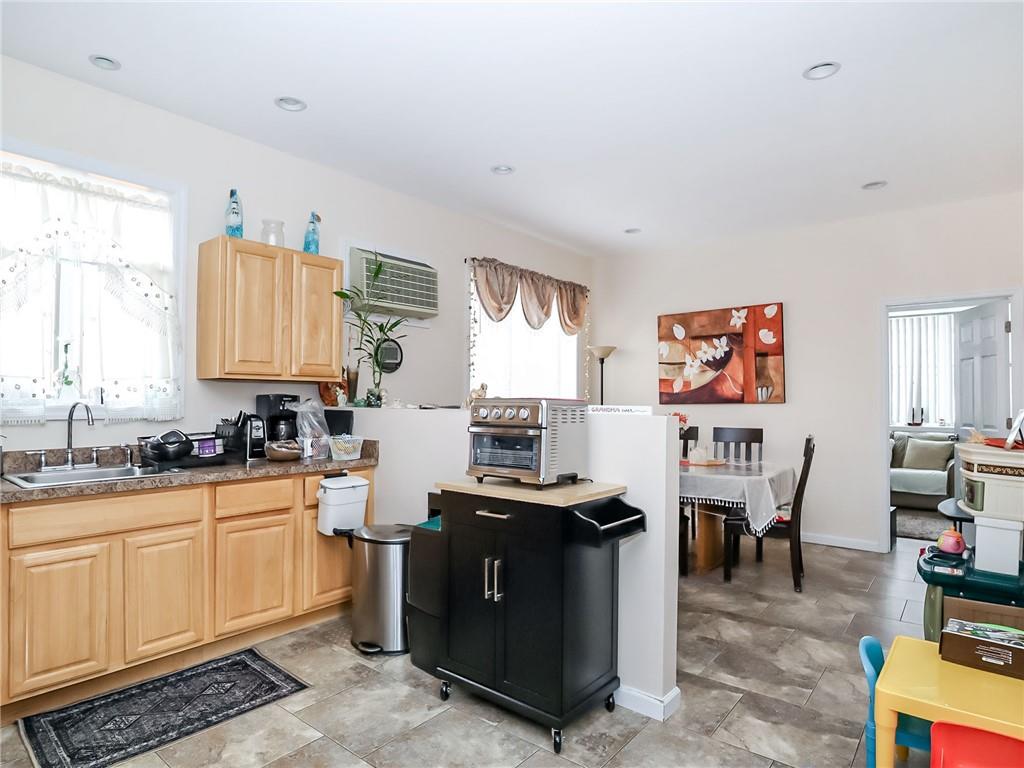 480 Van Sicklen Street Brooklyn, NY 11223 - Photo 23 of 31 a kitchen with stainless steel appliances granite countertop a stove top oven a sink dishwasher and cabinets with wooden floor