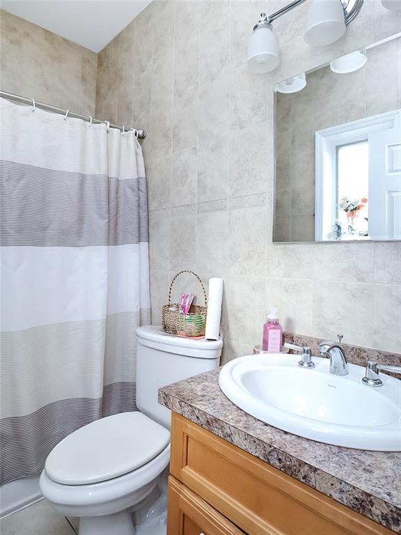 480 Van Sicklen Street Brooklyn, NY 11223 - Photo 25 of 31 a bathroom with a sink a toilet and a mirror