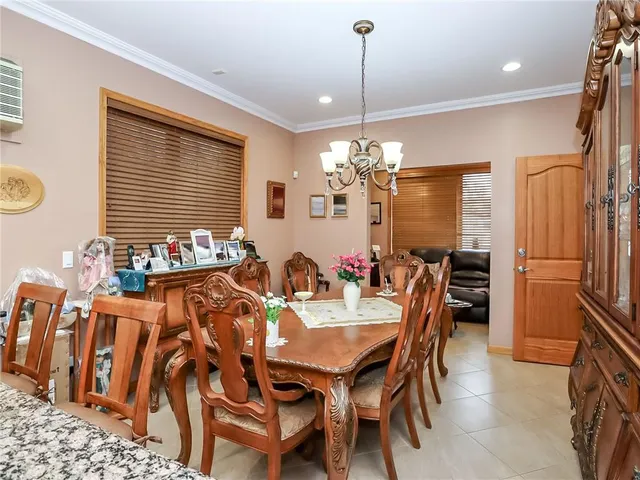 a view of a dining room with furniture and chandelier