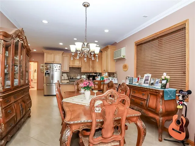 a view of a dining room and livingroom with furniture wooden floor a chandelier